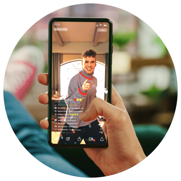 A close up image of a hand viewing a male internet superstar pointing at the viewer.